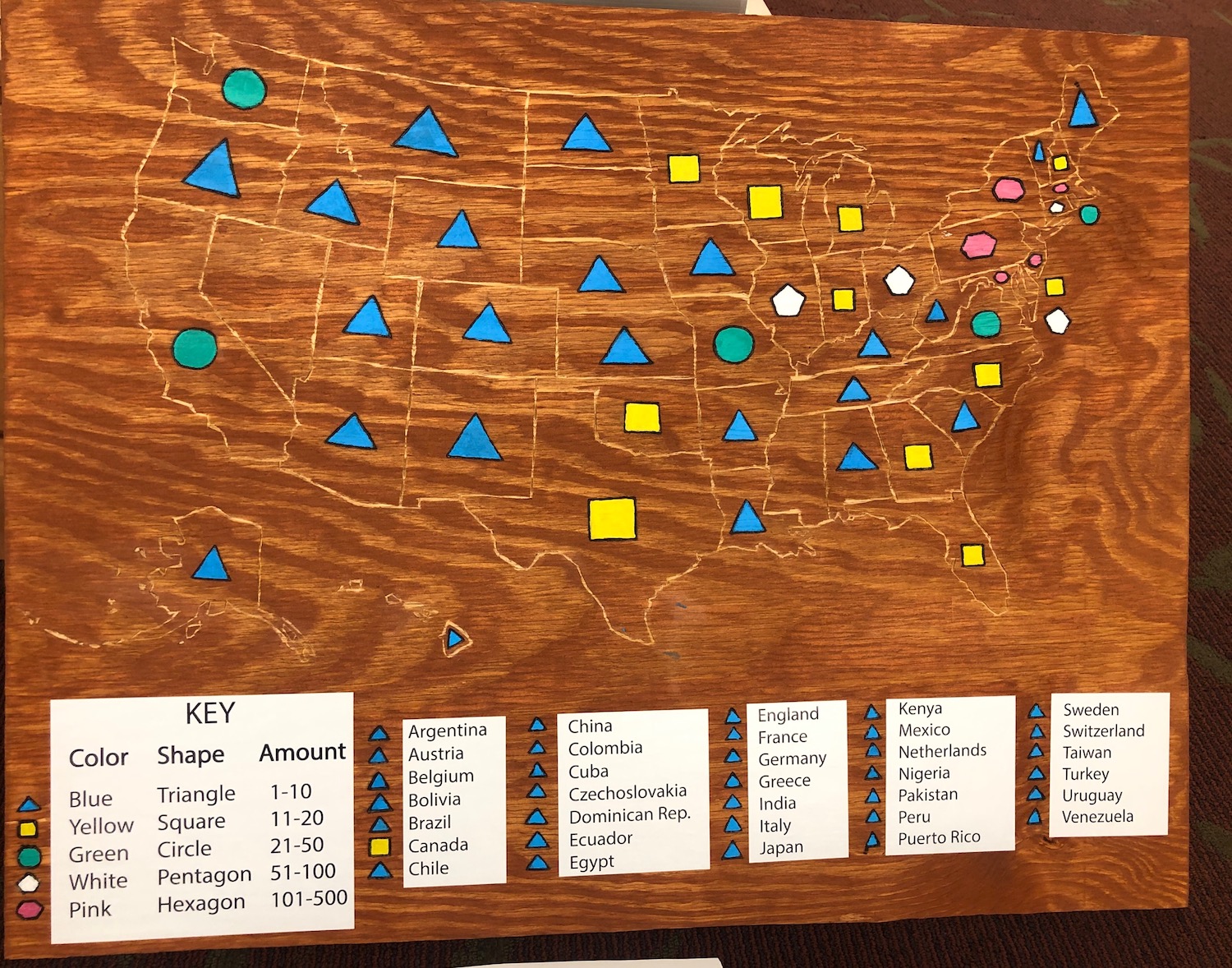 Wooden map of the USA with colored shapes on each state