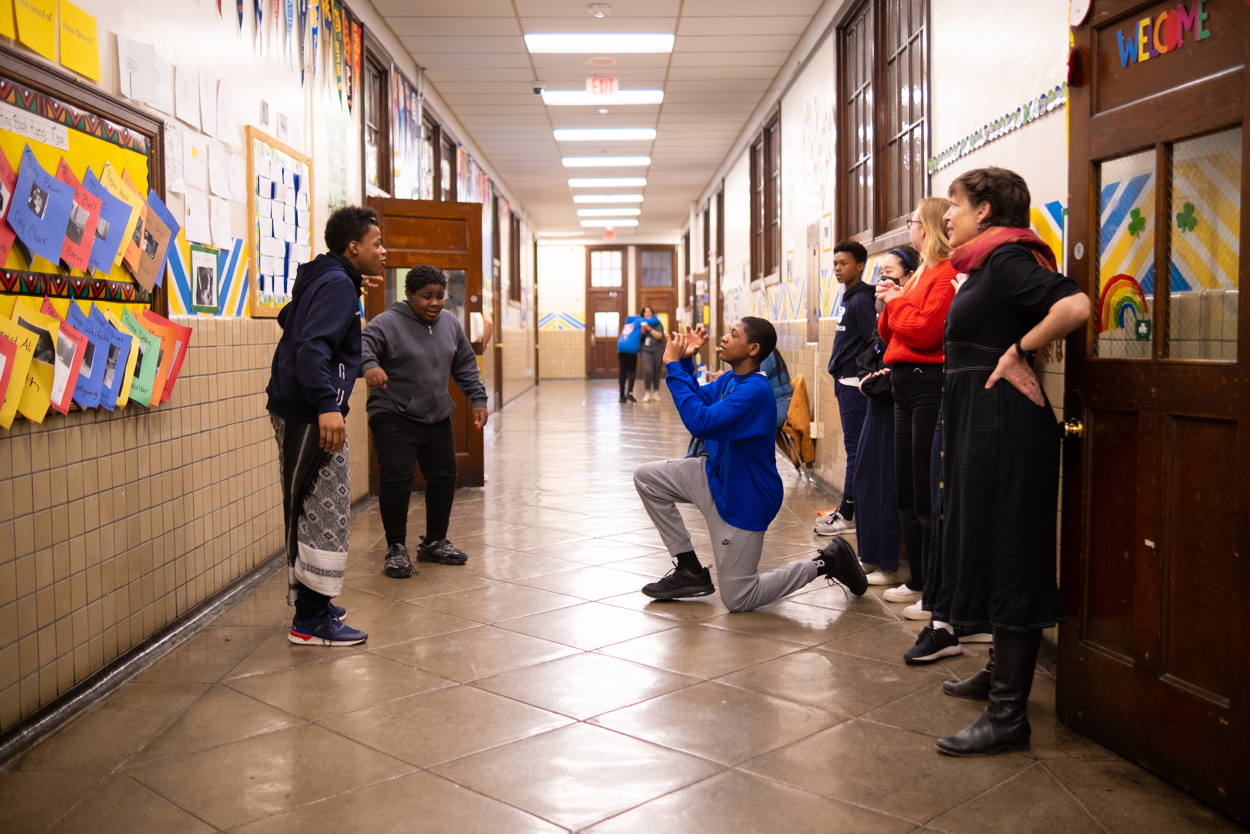 Image of Black middle school students with expressive body language.