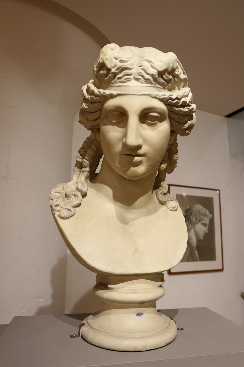 Bust of a woman's head inside a gallery
