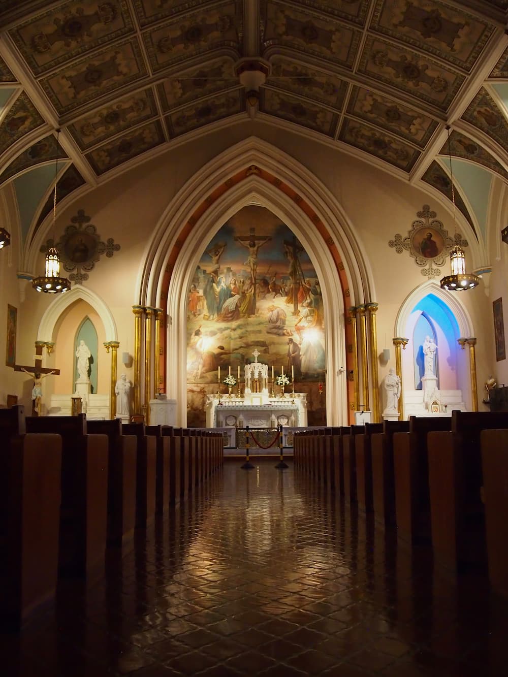 Inside of a church, down the center aisle