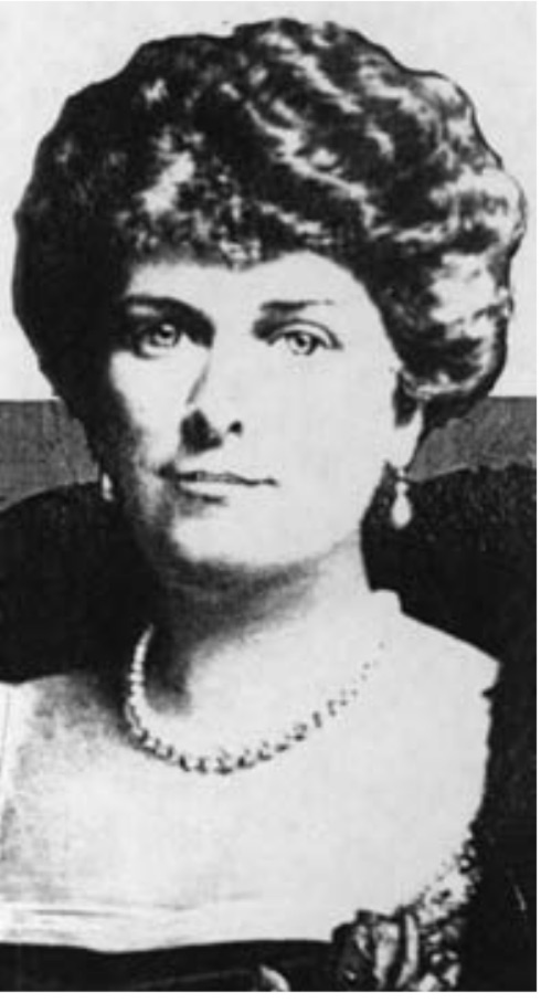Black and white photograph of a woman with short brown hair and a pearl necklace 