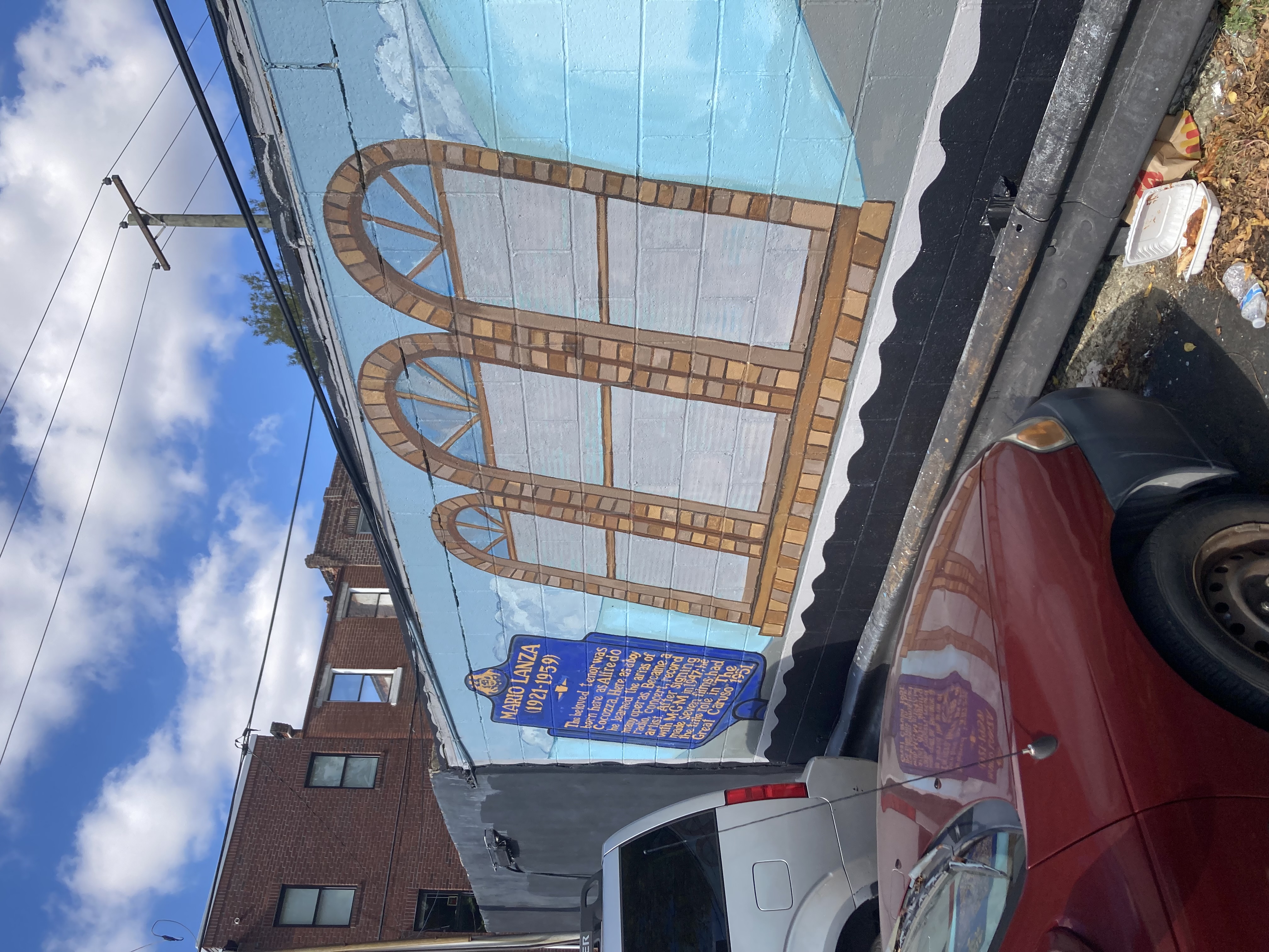 A plaque with a brief biography of Mario Lanza, framed on its right by a set of almost-Palladian-style windows