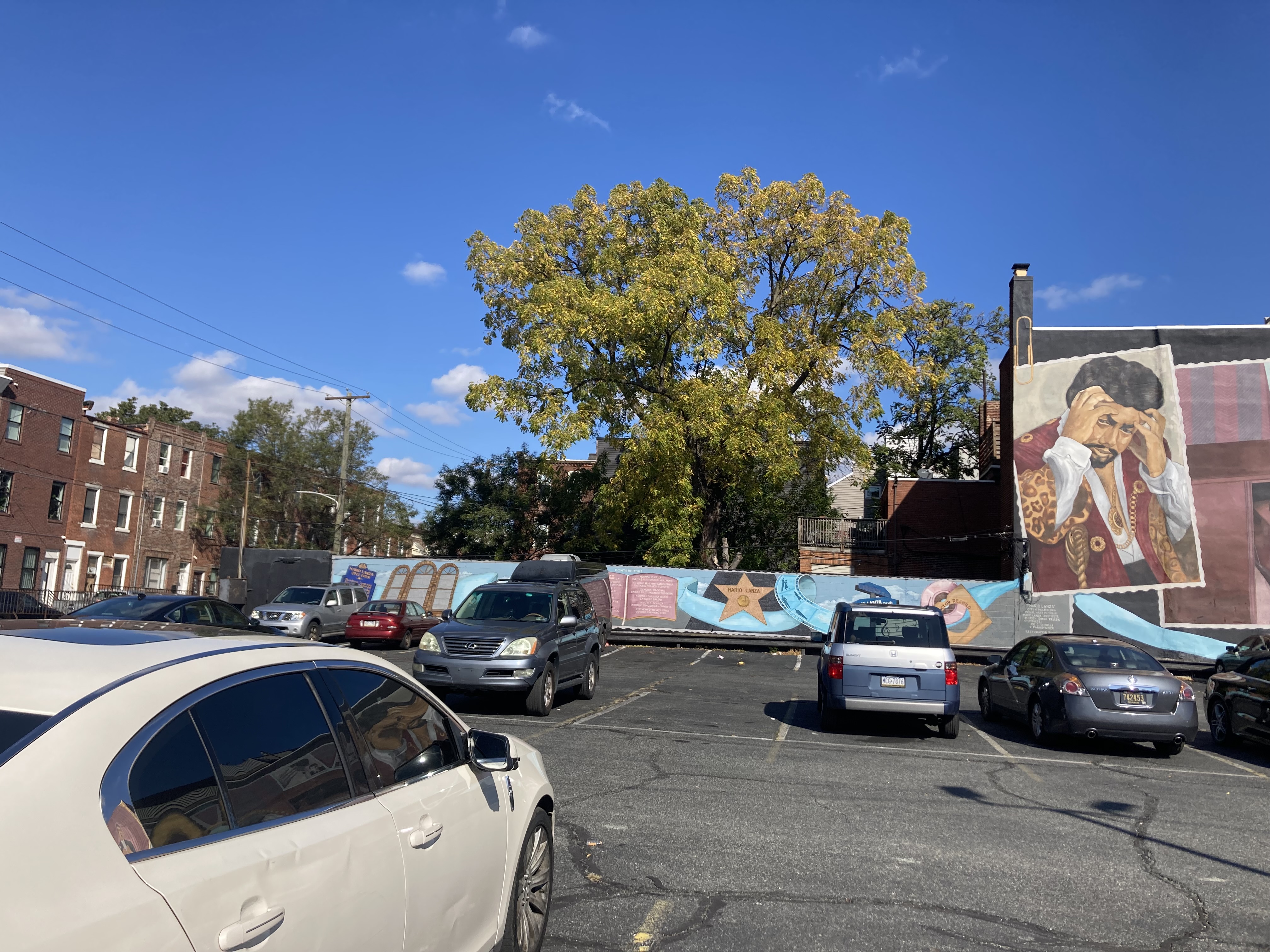 The smaller section of the mural next to its main pieces, stretching across the entire parking lot.