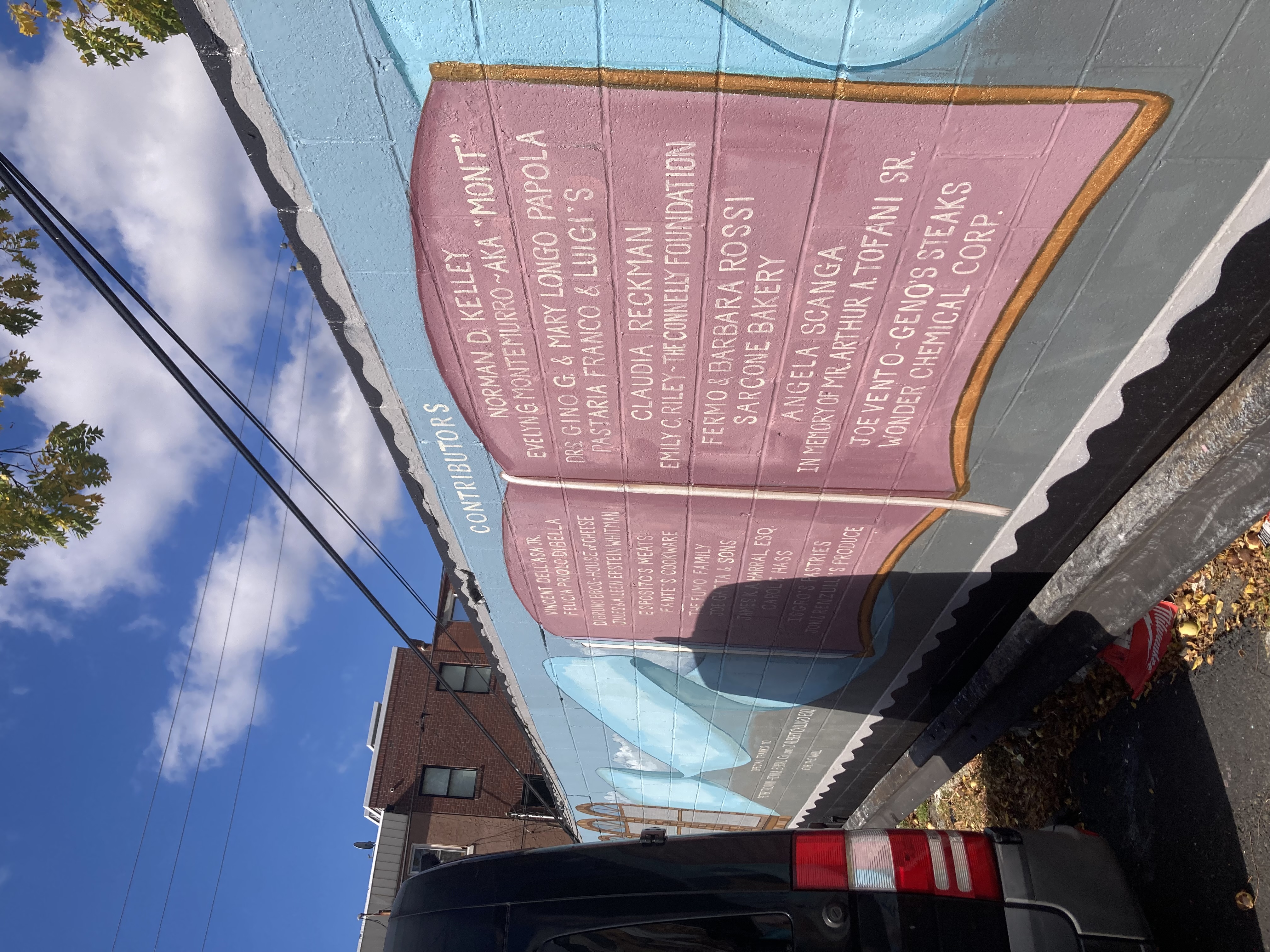 List of additional mural contributors depicted on a purple book with yellow outline.