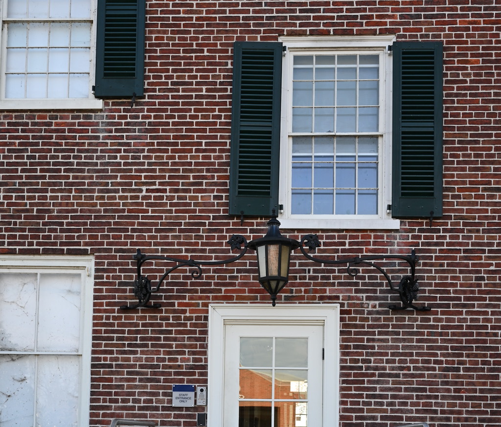 The iron light fixture is still installed on the north façade.