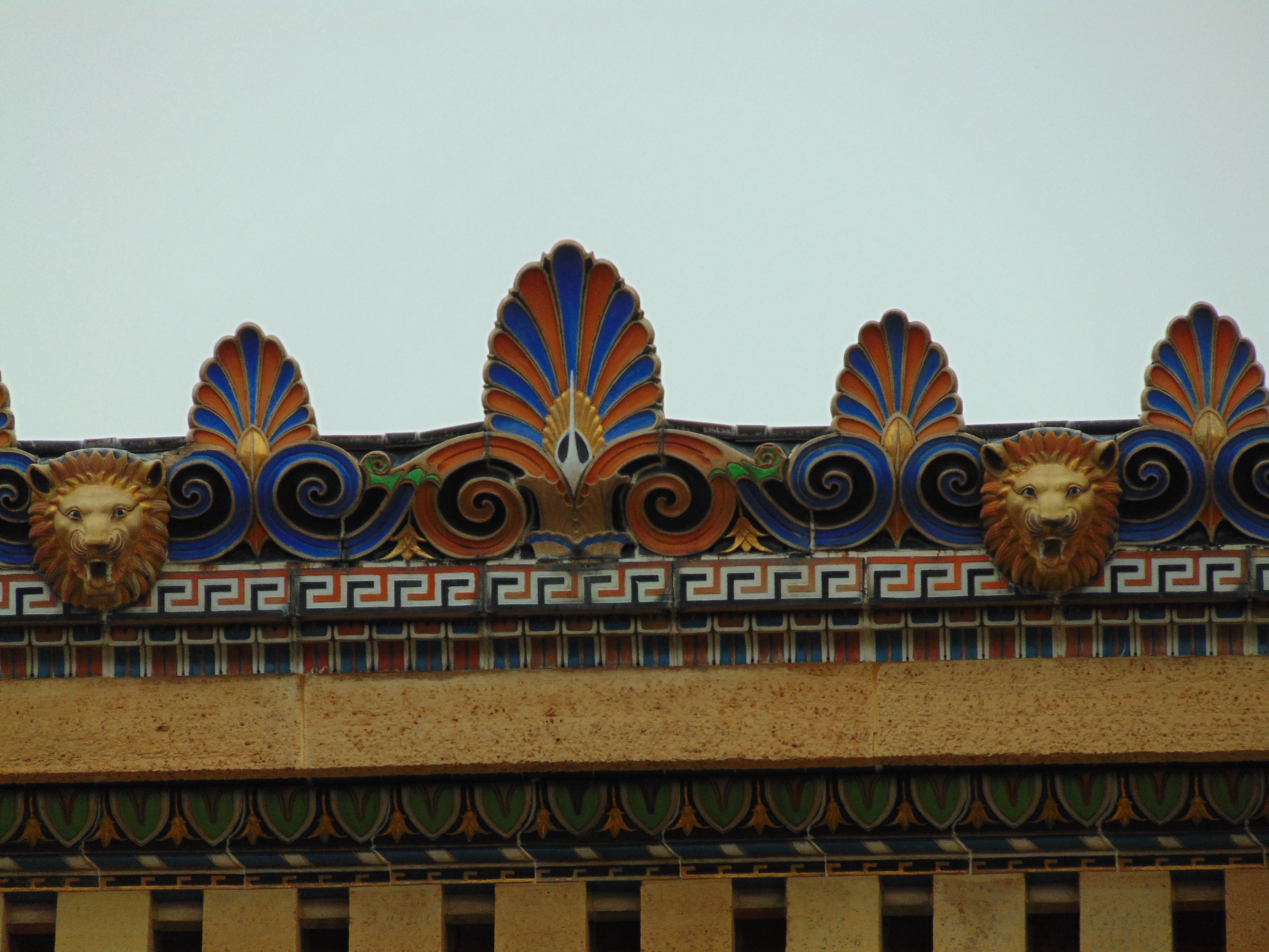 Ornate pediment detailing with lion heads.